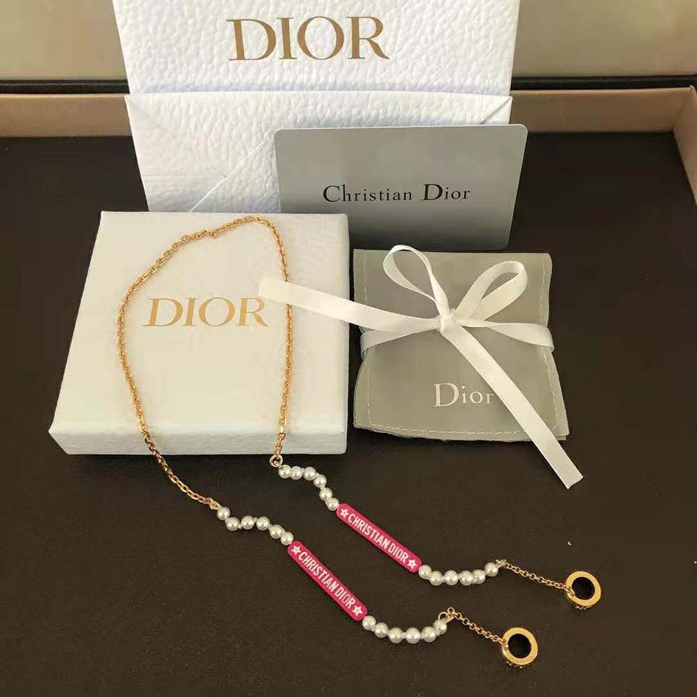 Close-up on pink resin pearls and gold-finish metal of Dior necklace