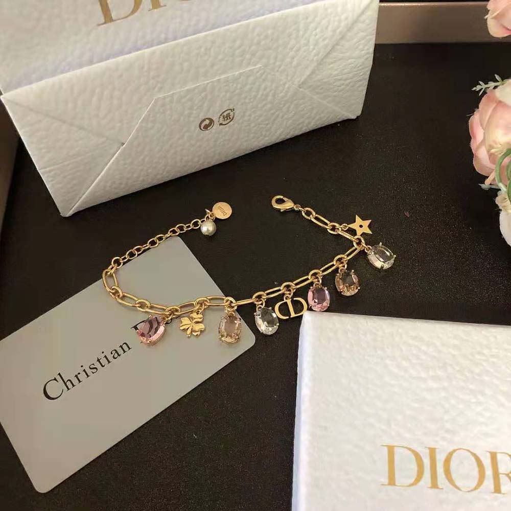 Close-up on white resin pearl and multicolor crystals details by Dior