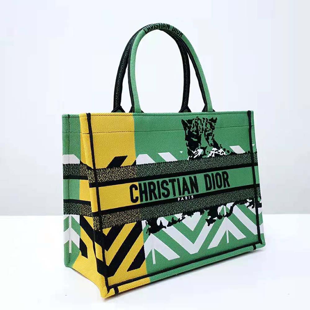 Side profile showing silver hardware and structured shape of Dior Women Medium Dior Book Tote
