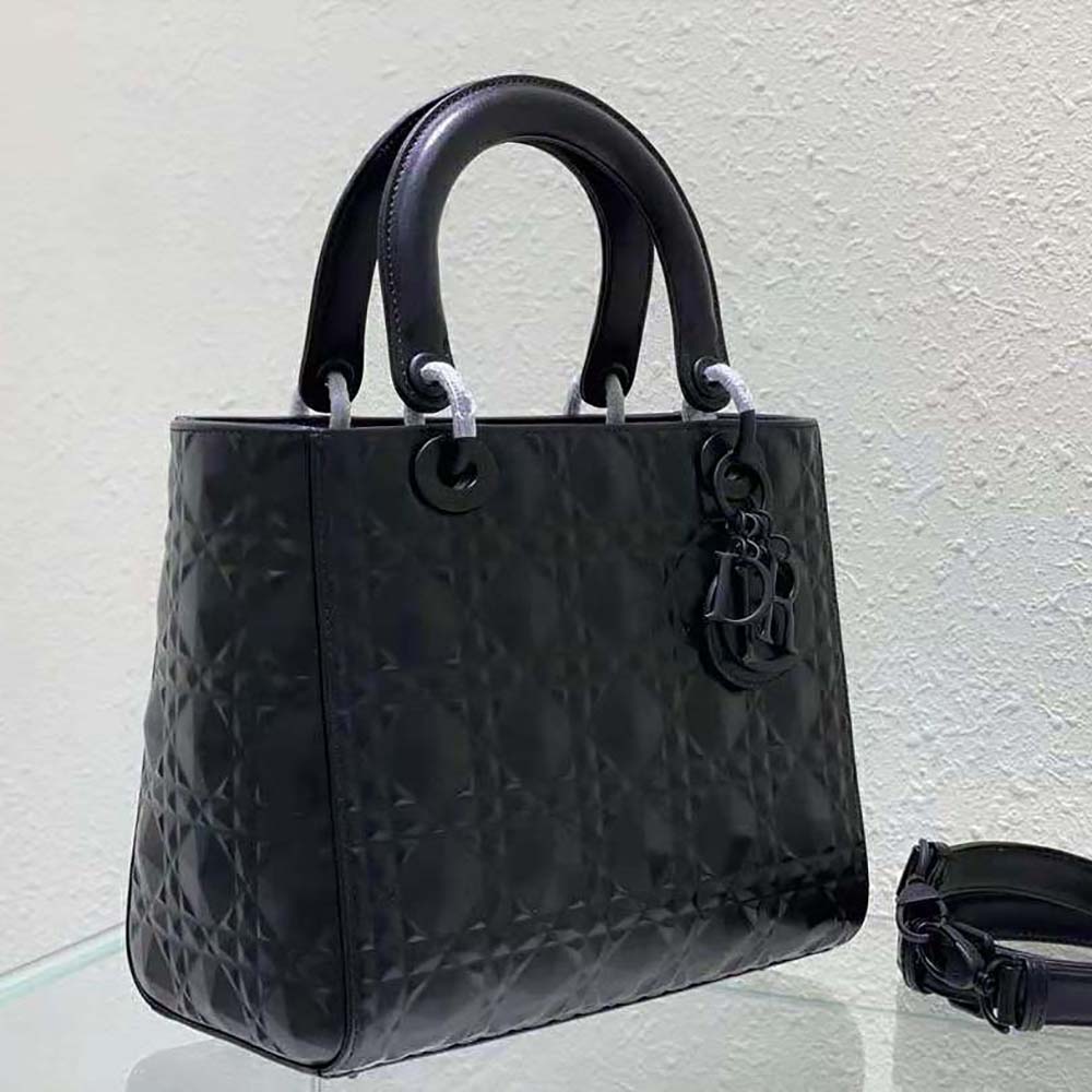 Side angle showing silver hardware and structured silhouette on Dior Women Medium Lady Dior Bag