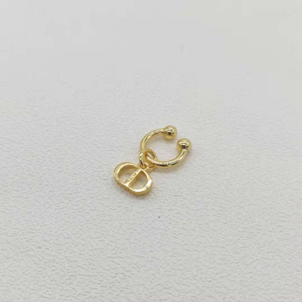 Dior Women Petit CD Ear Jewelry displayed against a soft fabric background