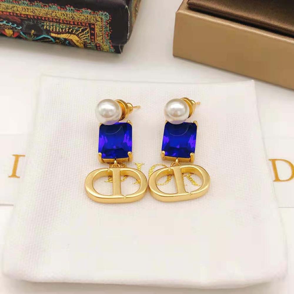 Side angle showing petite silhouette of Dior Women Petit CD Earrings