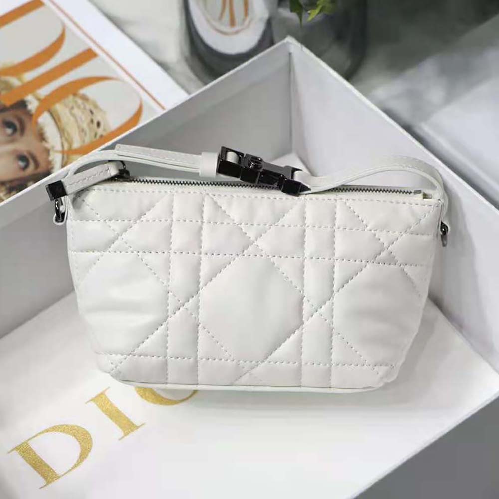 Close-up detail of white calfskin and macrocannage pattern on Dior pouch