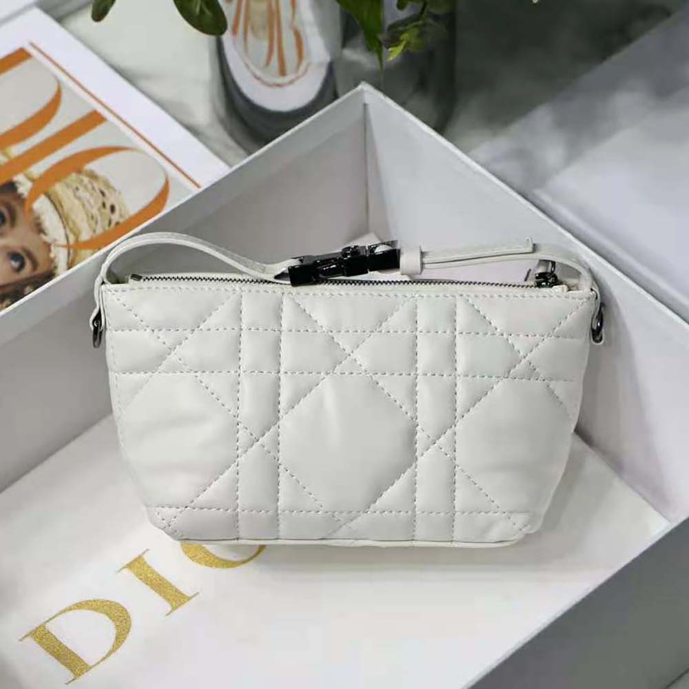 Side angle showing silver hardware and compact silhouette of Dior pouch