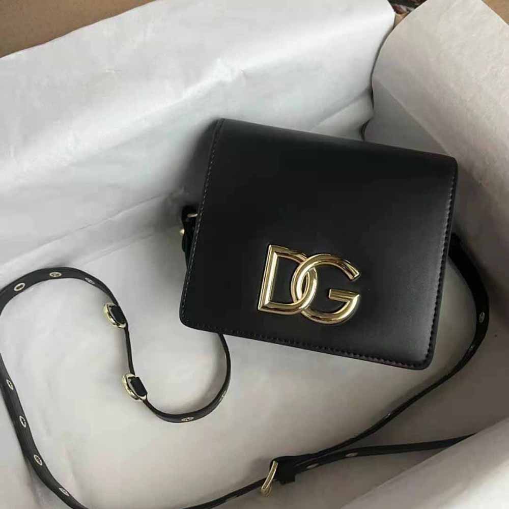 Close-up of gold-tone D&G logo hardware on black calfskin bag