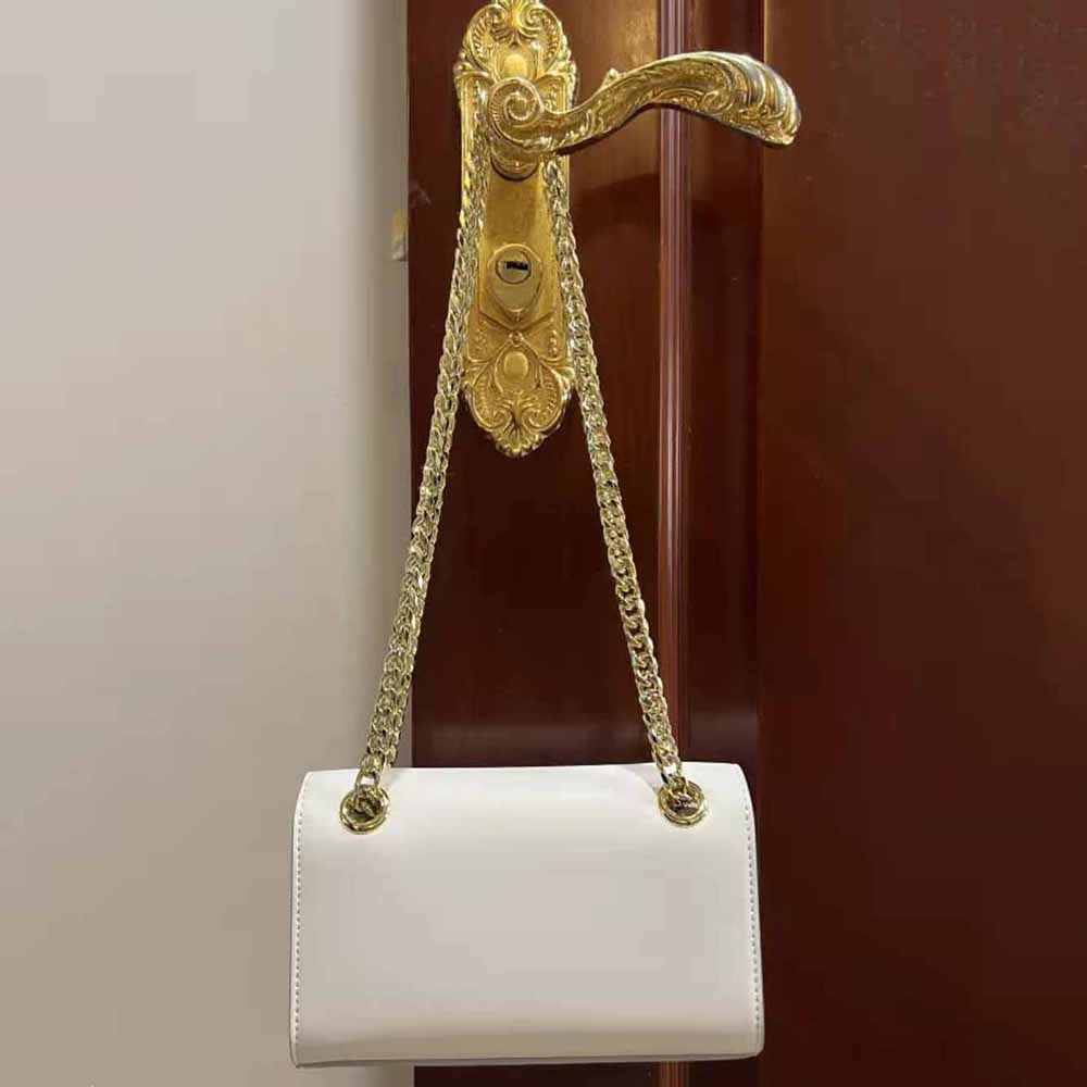 Side profile showing slim silhouette and flap closure of Dolce Gabbana phone bag