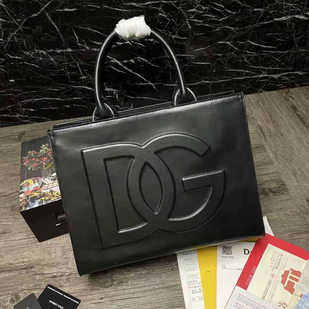 Close-up of black calfskin texture and DG logo hardware on DG Daily Shopper