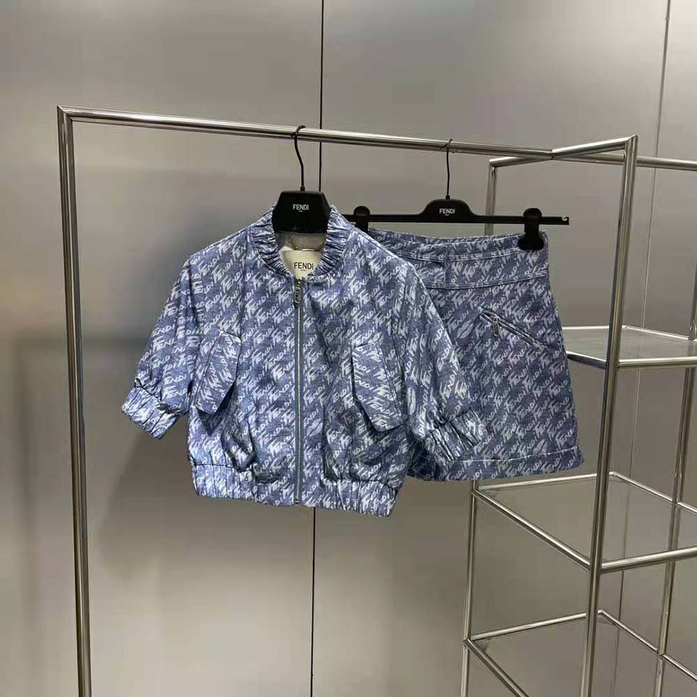 Close-up of signature Fendi hardware on blue chambray shorts waistband