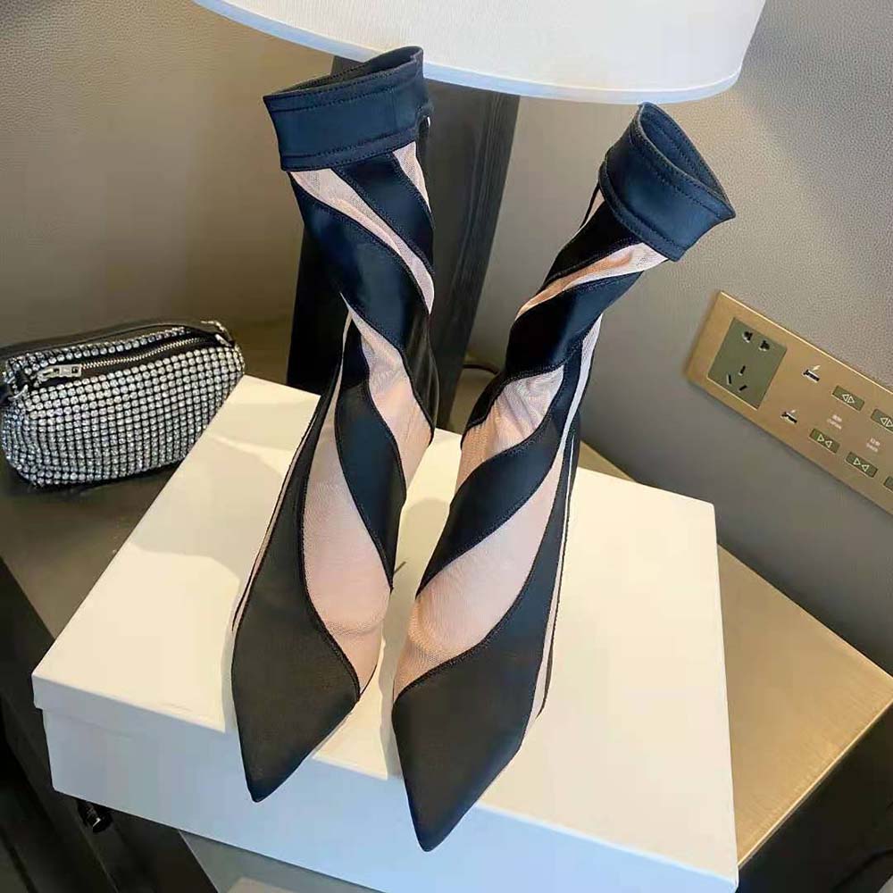 Close-up detail of spiral stretch fabric and logo hardware on Jimmy Choo boot
