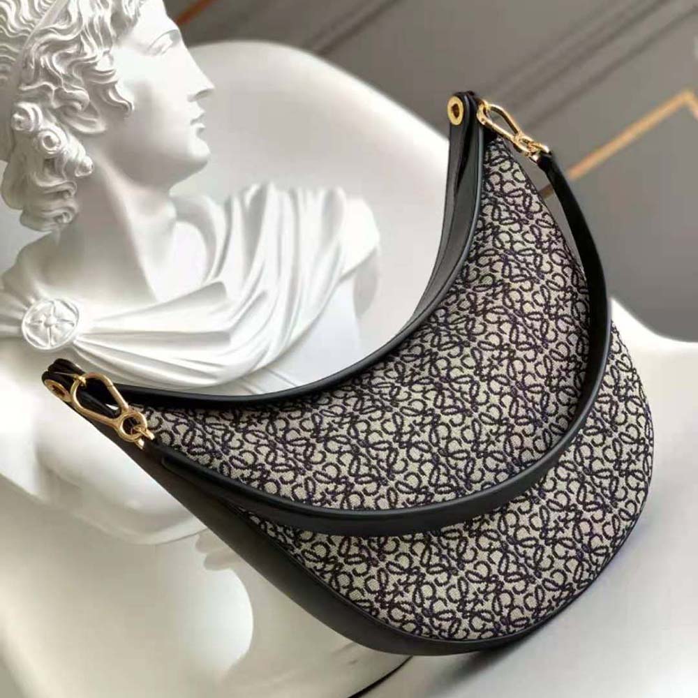 Side profile showing the flap closure and strap of Loewe Women Luna Bag