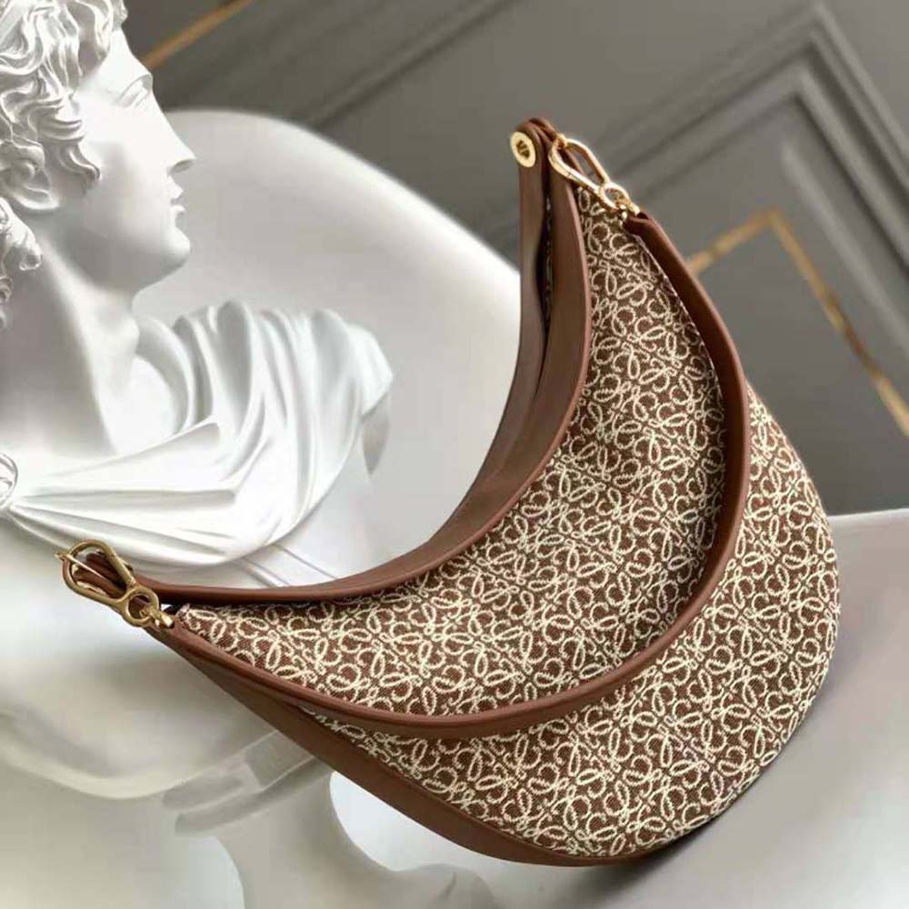 Side profile showing adjustable strap on Loewe Women Luna Bag in brown