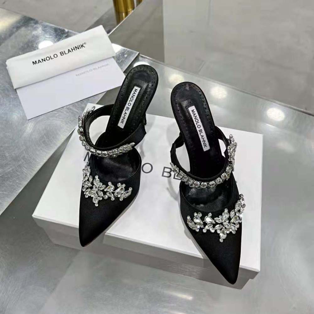 Rear angle showing heel height of Manolo Blahnik black satin mules