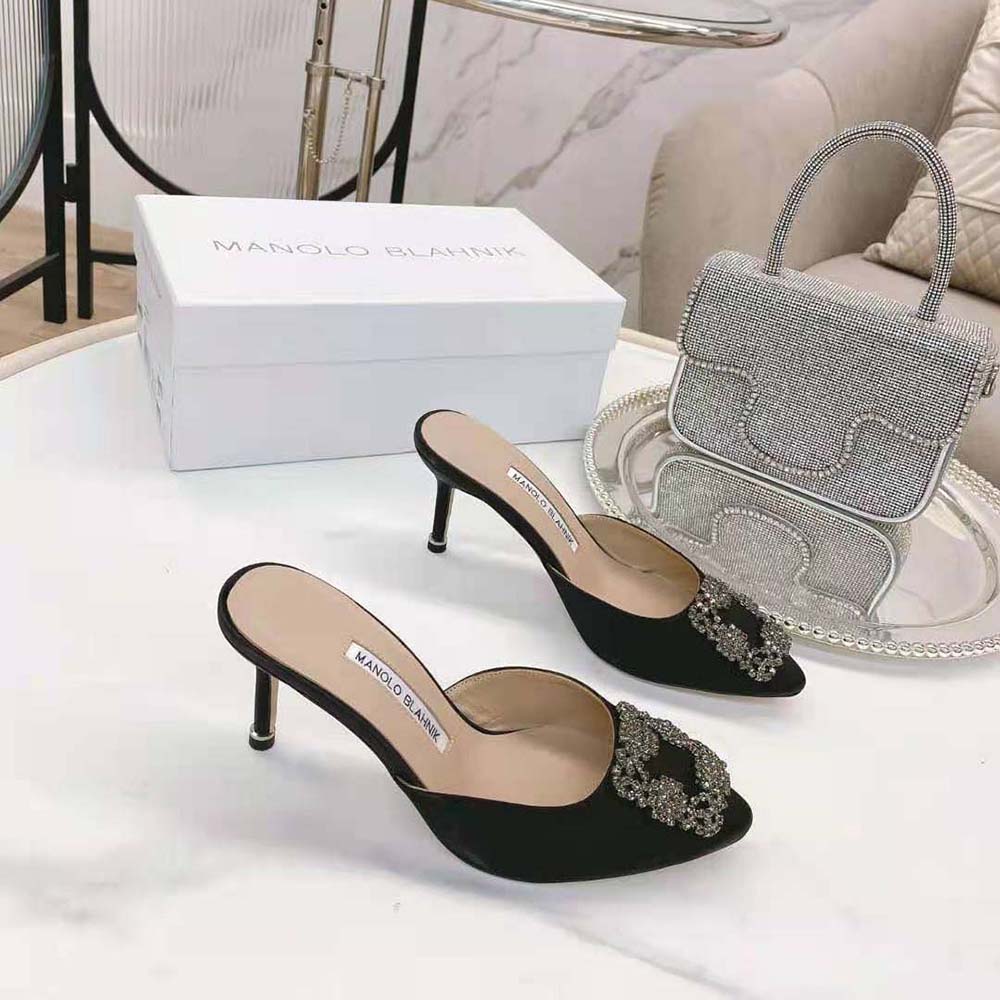 Top view highlighting sleek black satin and silhouette of Manolo Blahnik Mules