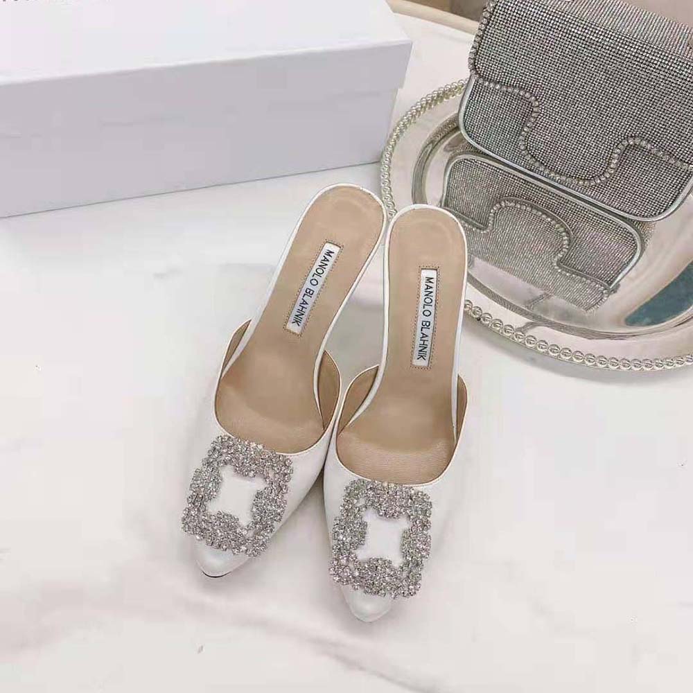 Close-up of jeweled buckle on Manolo Blahnik Off-White Satin Mules