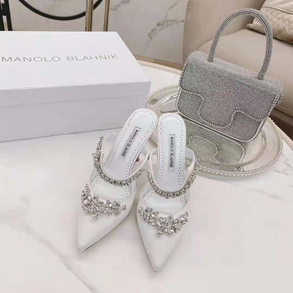 Side view showing high heel and satin texture of Manolo Blahnik mules