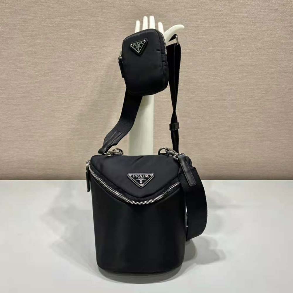Close-up on silver-tone Prada logo hardware on black Re-Nylon bag
