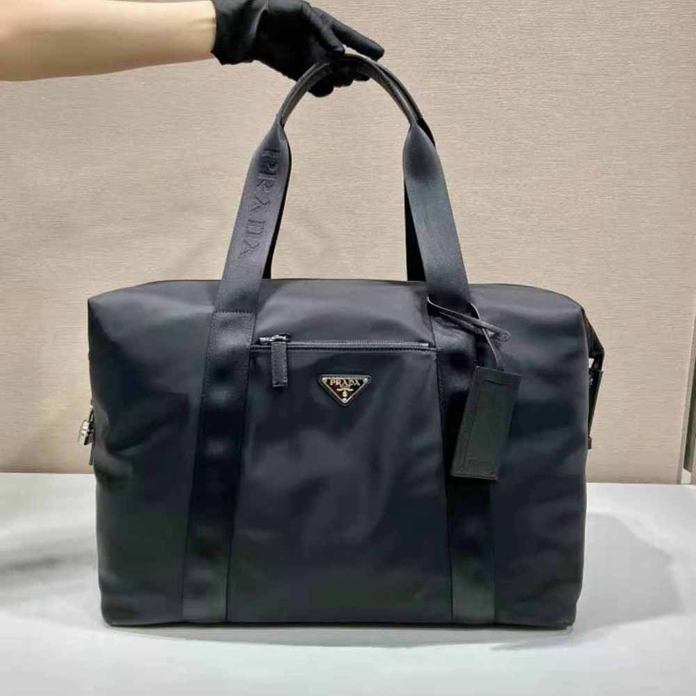Close-up of Prada logo and silver hardware on the black duffle bag