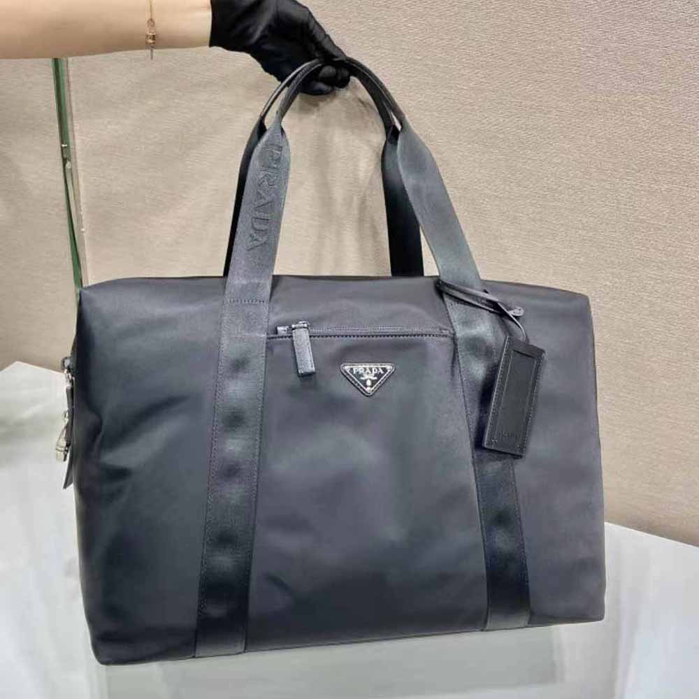 Side angle showing zipper and leather trim details on Prada duffle