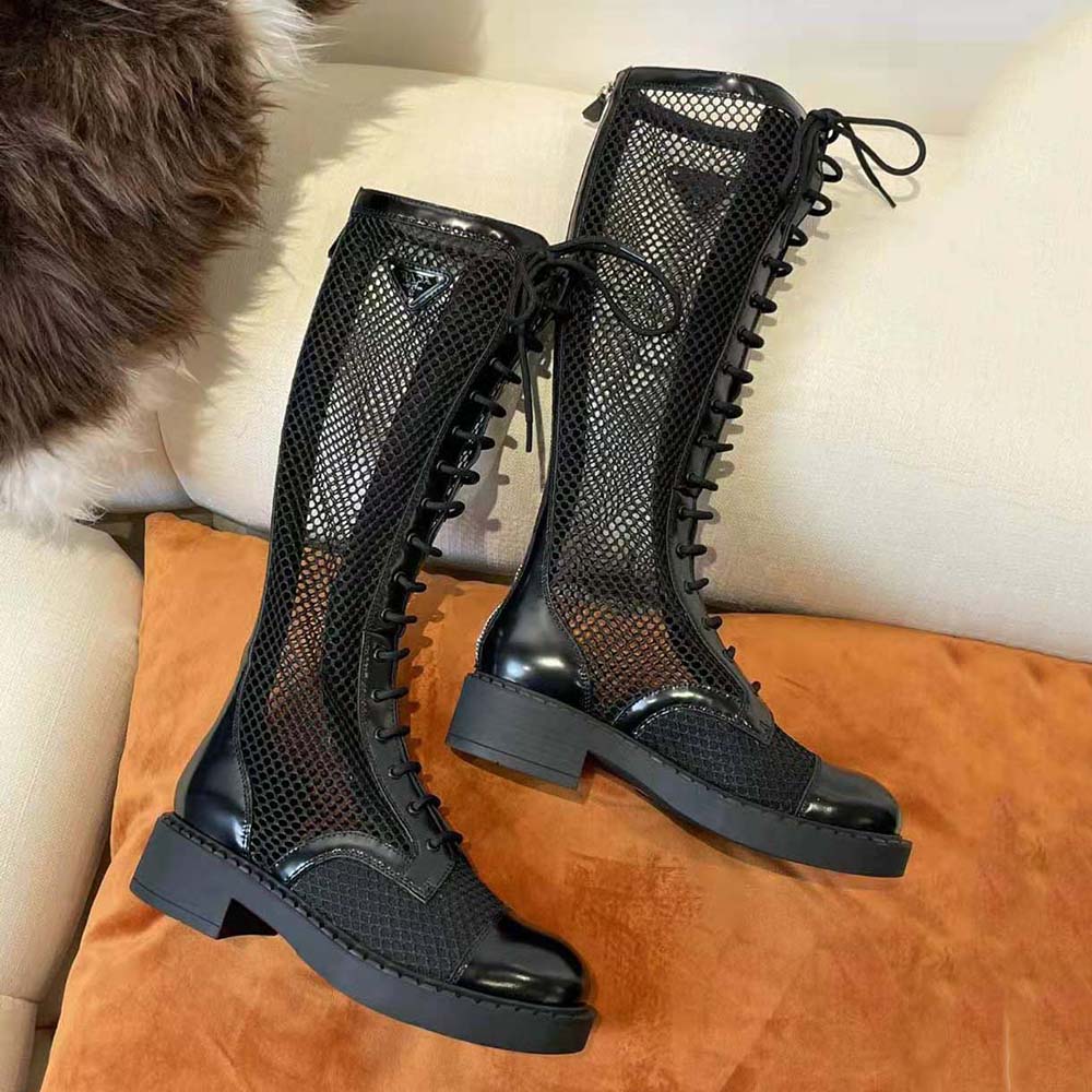 Close-up on brushed leather and Prada logo detail on boots