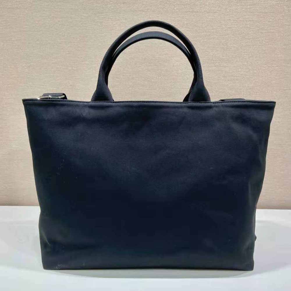 Side angle showing magnetic closure and leather trim of Prada Women Canvas Tote Bag