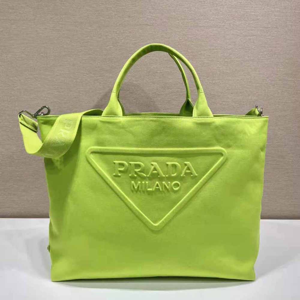 Close-up of silver-tone logo and zip on Prada lime tote bag