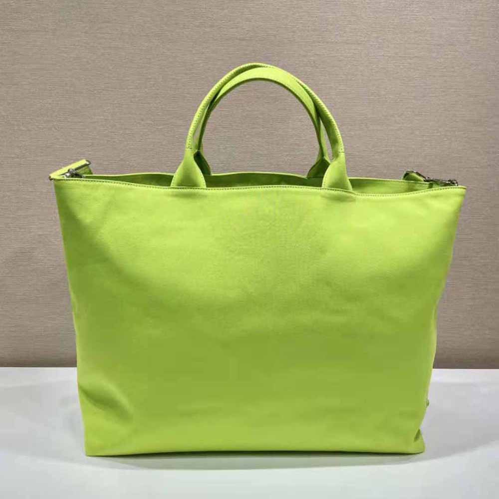Side view showing leather trim and structured silhouette of Prada tote