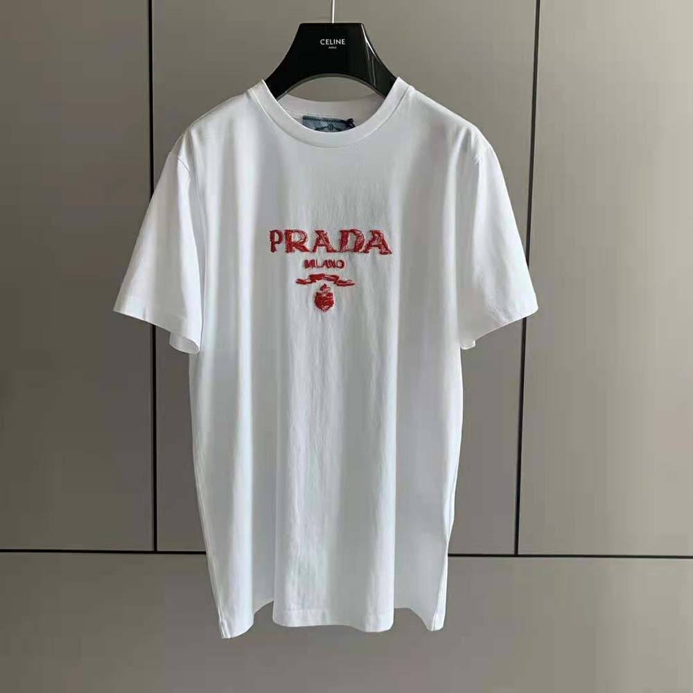Close-up of embroidered Prada logo on red cotton T-shirt
