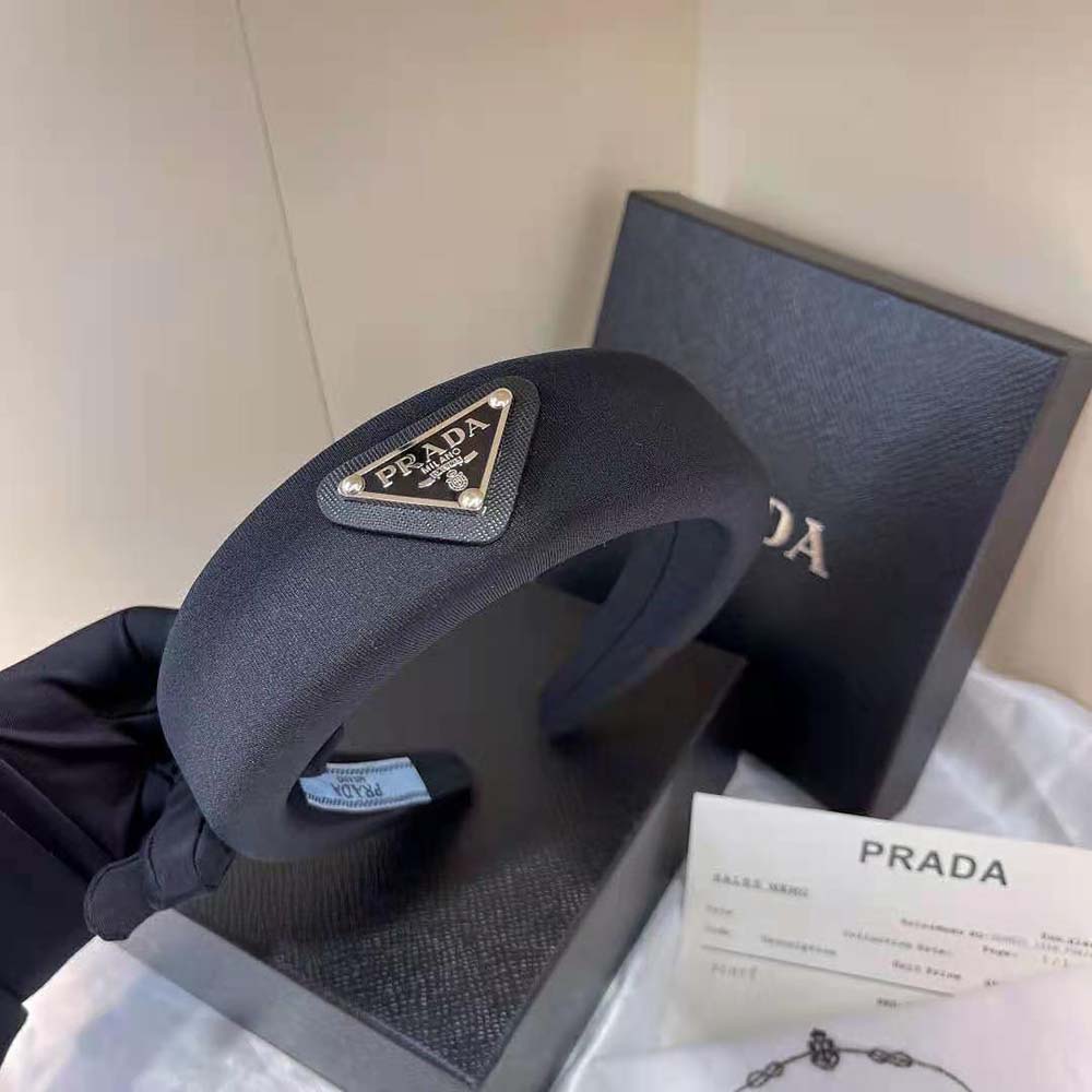Close-up of padded silhouette and Prada logo on black headband