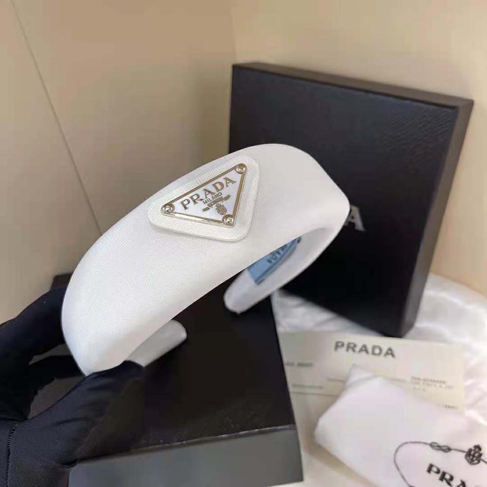 Close-up showing Prada logo detail on white puffy headband