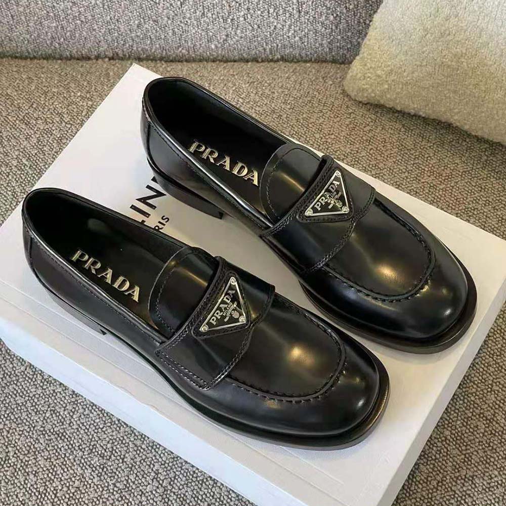 Close-up on black patent leather and signature Prada logo detail