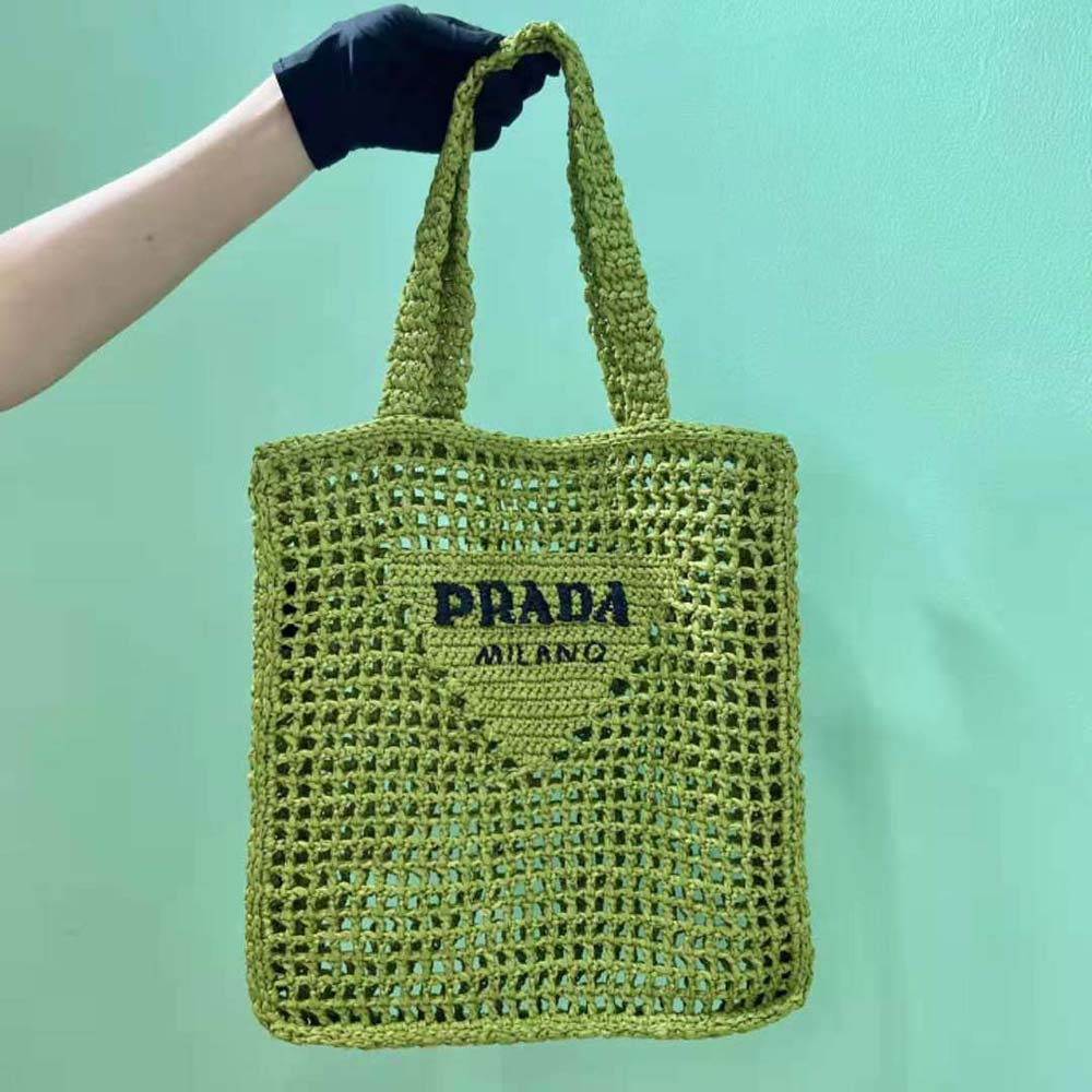 Close-up of gold-tone logo plaque on Prada Women Raffia Tote Bag with A Soft-Lime