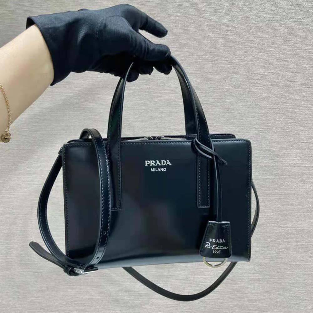 Close-up of Prada triangle logo hardware on handbag front
