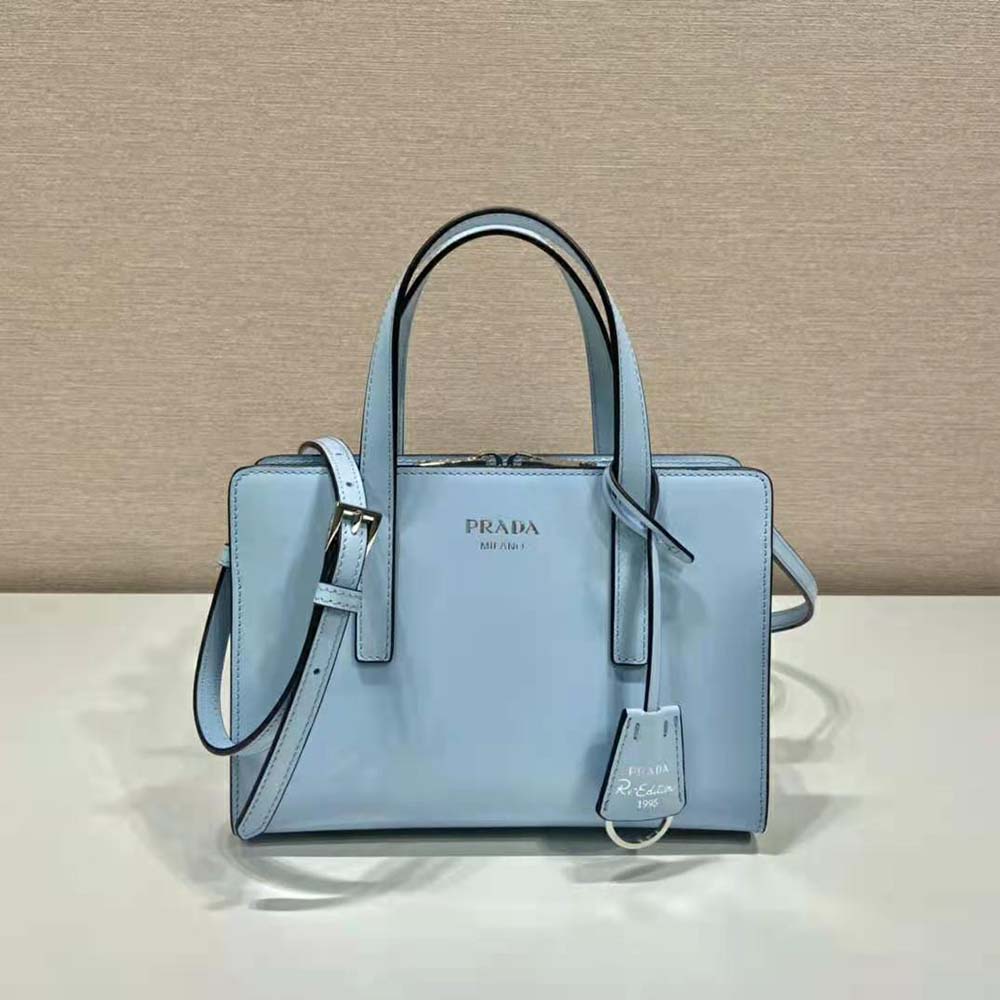 Side angle showing snap closure detail on Prada brushed-leather mini handbag