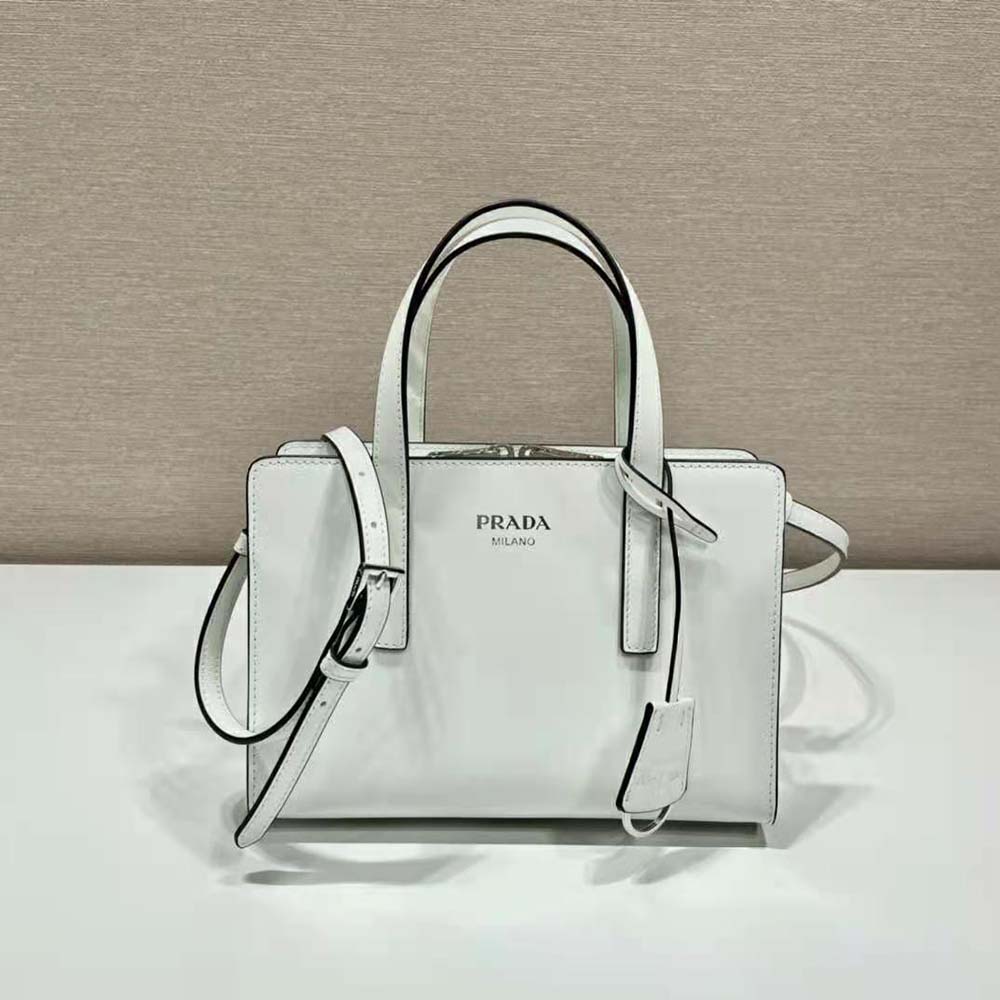 Side angle showing silver-tone hardware on Prada white mini handbag