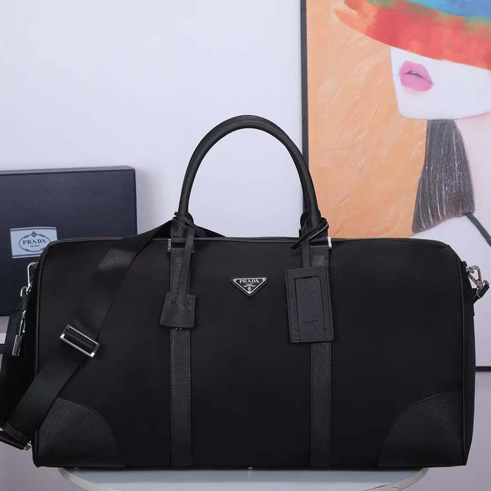 Close-up detail of silver-tone hardware on Prada Men Re-Nylon and Saffiano Leather Duffle Bag-Black