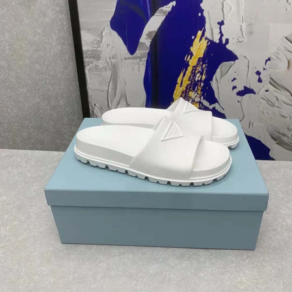 Close-up of embossed Prada logo on white rubber slide upper