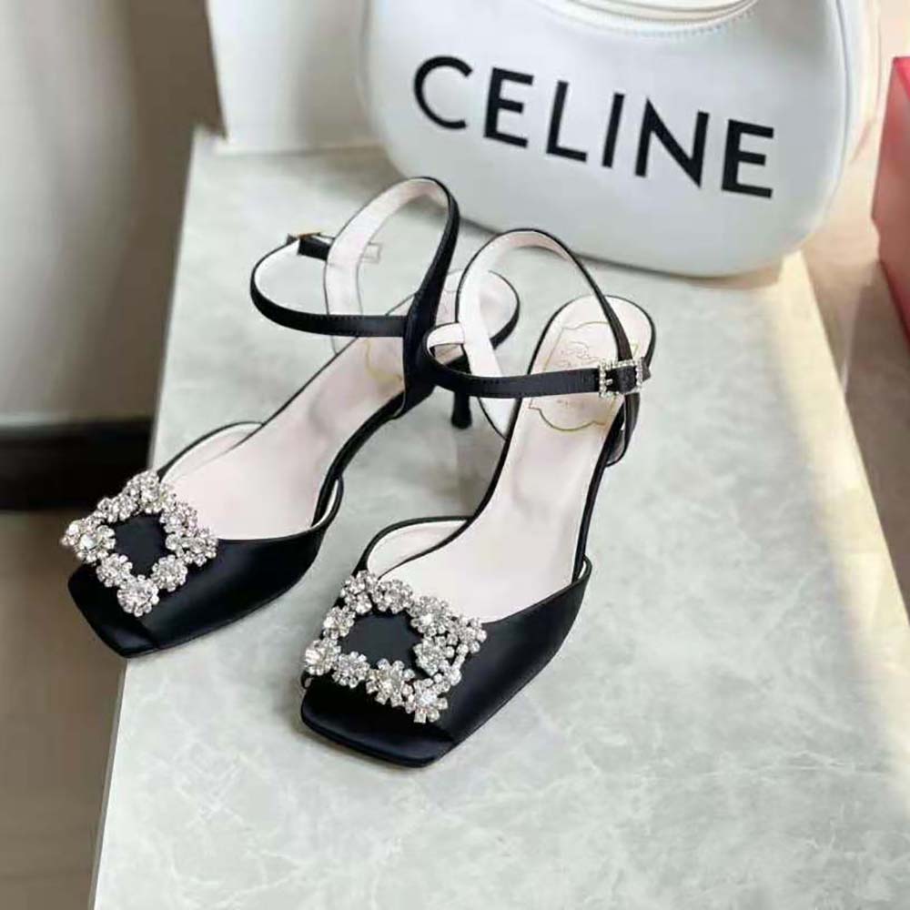 Close-up of signature flower strass buckle on Roger Vivier satin sandals