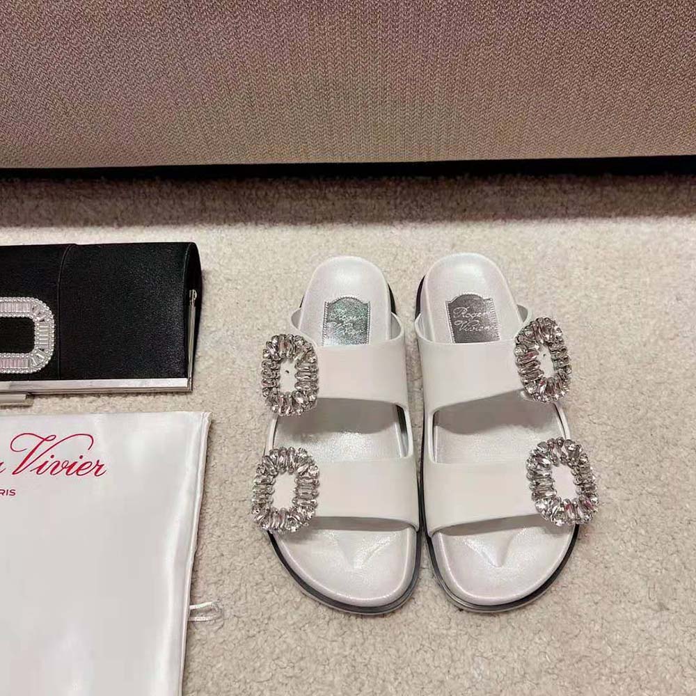 Top view of white fabric and adjustable buckle on Roger Vivier sandals