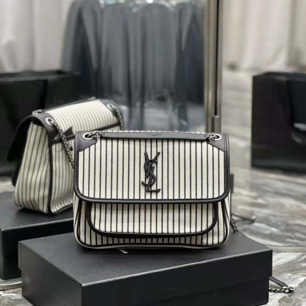 Close-up of gold YSL chain hardware on the Saint Laurent Niki Medium Bag