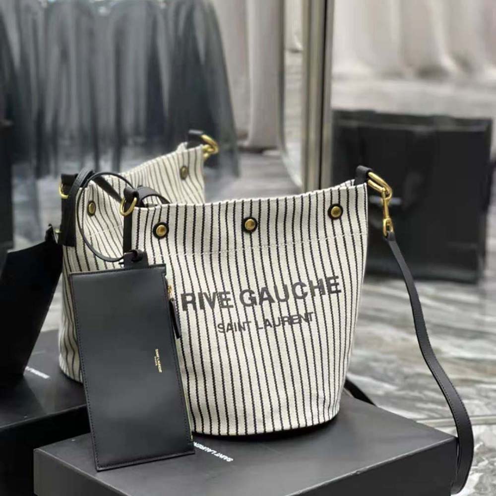 Side profile showing black leather trim and adjustable strap on Saint Laurent YSL Bucket Bag