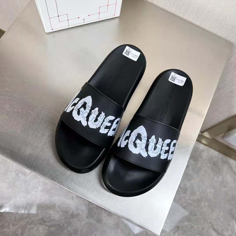 Close-up of bold graffiti print on Alexander Mcqueen rubber slide strap