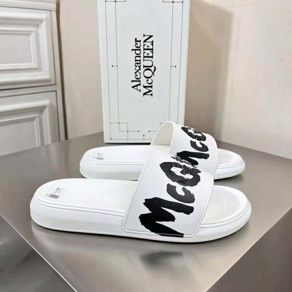 Close-up of the black sole and white strap on Alexander Mcqueen rubber slide