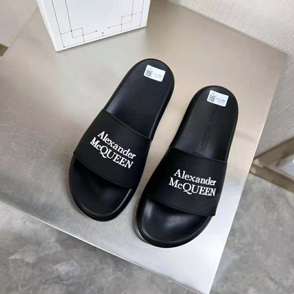 Close-up of raised Alexander Mcqueen logo on pool slide strap