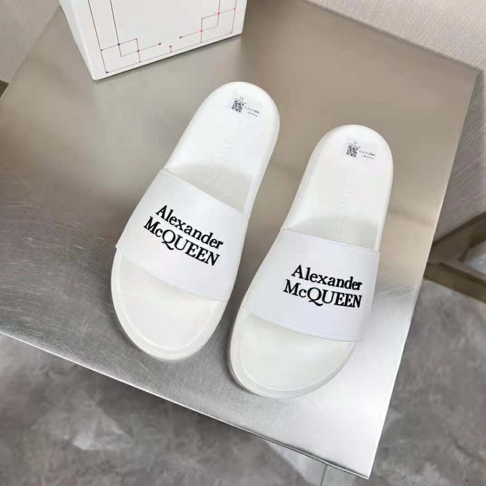 Close-up of black branding on white Alexander Mcqueen Unisex Pool Slide strap