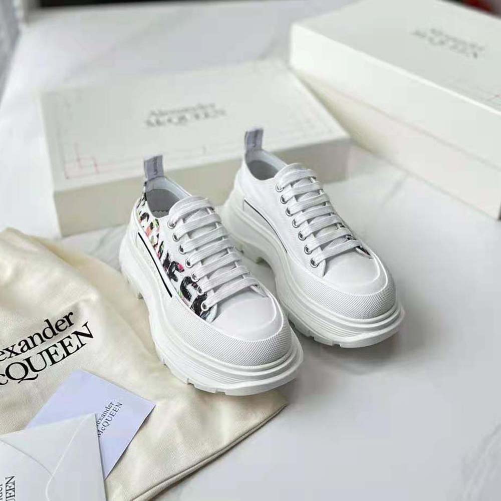 Close-up on white leather and treaded sole of Alexander Mcqueen sneakers