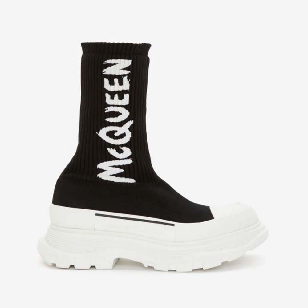 Side view of Alexander Mcqueen Women McQueen Graffiti Knit Tread Slick Boot in black and white