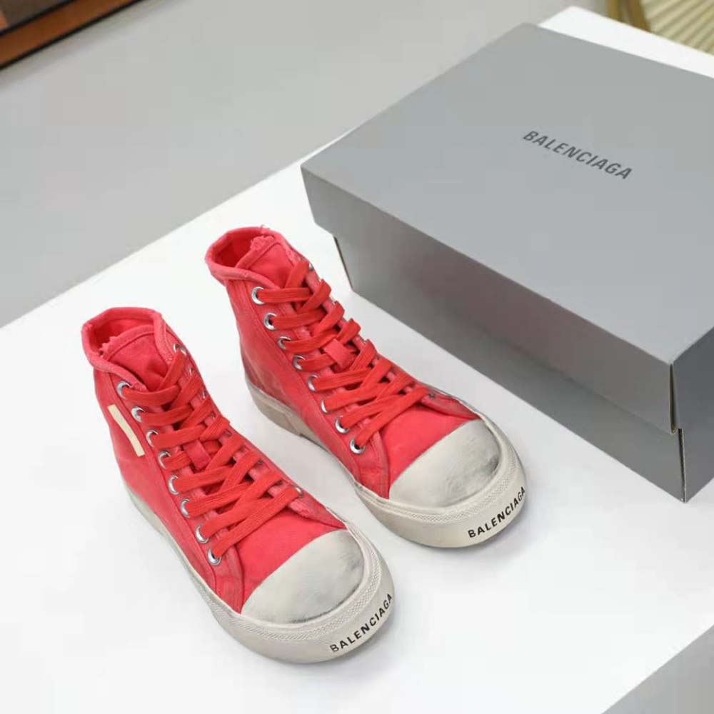 Close-up on destroyed cotton texture and white rubber sole of Balenciaga sneaker