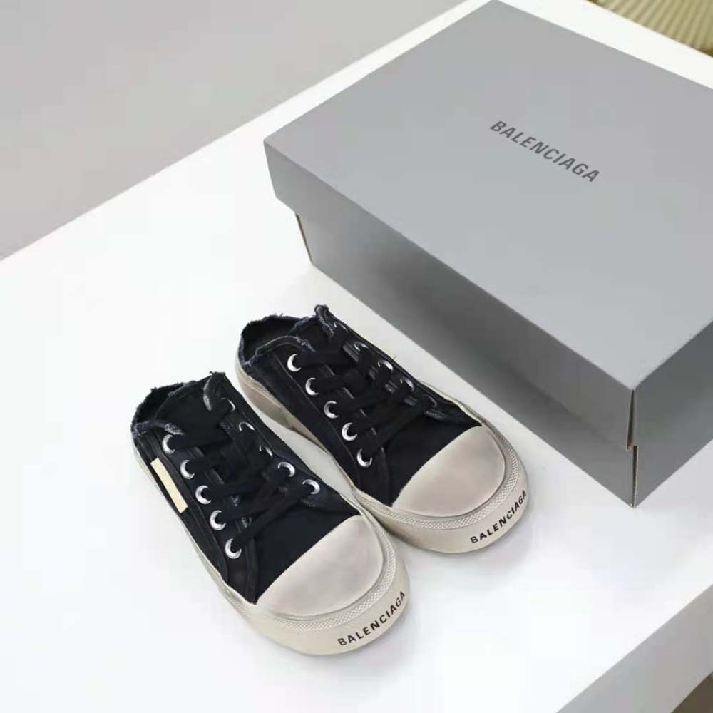 Close-up on white rubber sole and destroyed cotton upper of Balenciaga mule