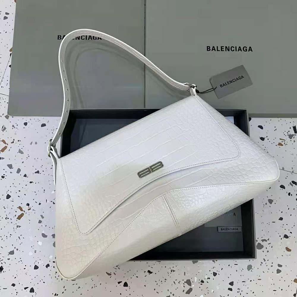 Close-up detail of crocodile embossing and silver hardware on Balenciaga bag