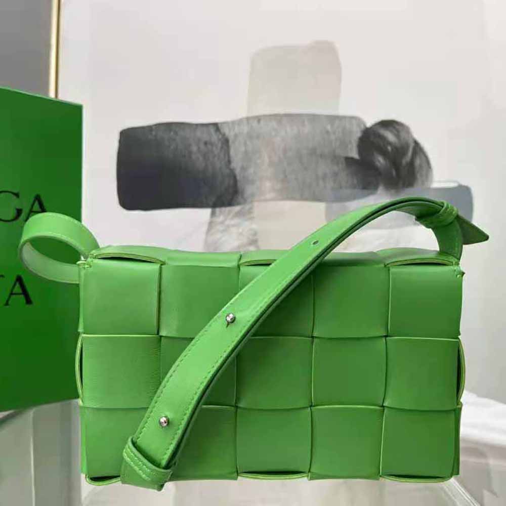 Side angle showing matte gold hardware and adjustable strap of Bottega Veneta Cassette bag
